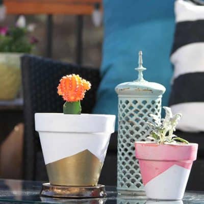 DIY tutorial on how to paint a planter with painter's tape and gold metallic spray paint