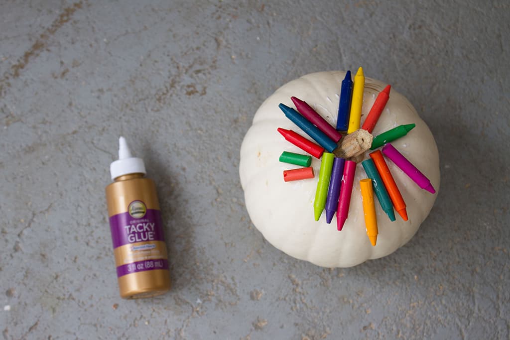 Audrey of Oh So Lovely Blog shares a fun and colorful DIY crayon drip pumpkin tutorial.