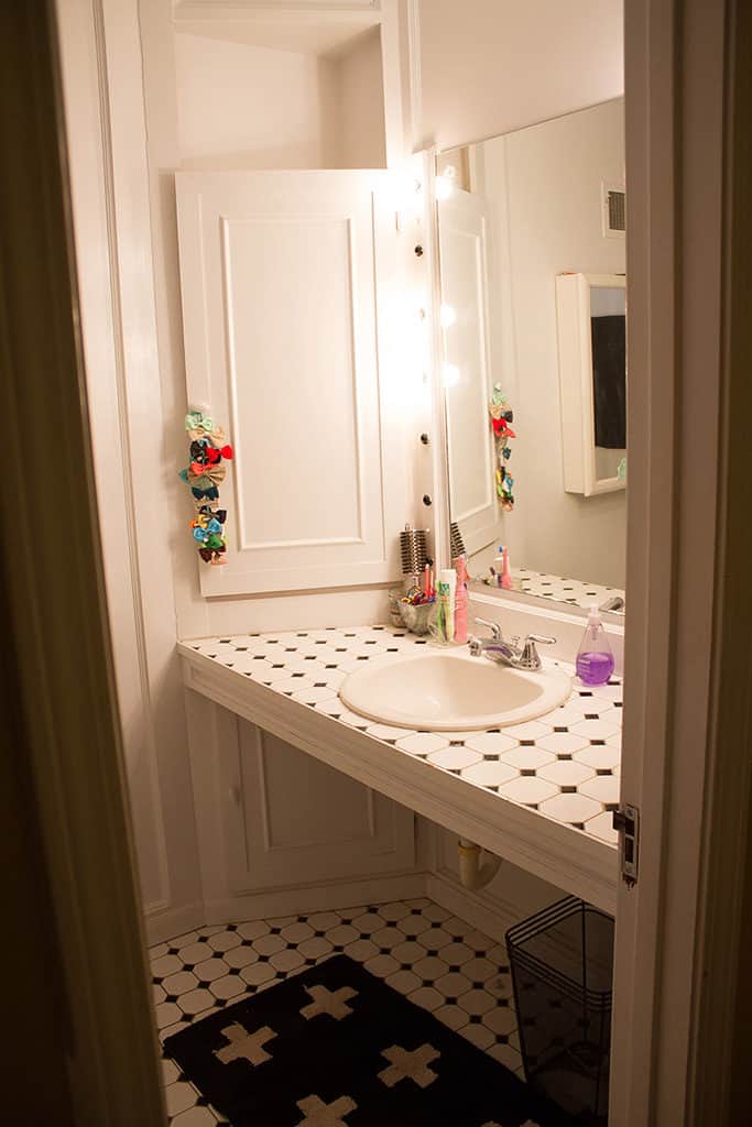 Audrey Kuether of Oh So Lovely Blog shares a guest bathroom remodel featuring a DIY custom vanity. See all the before and after photos and products used.