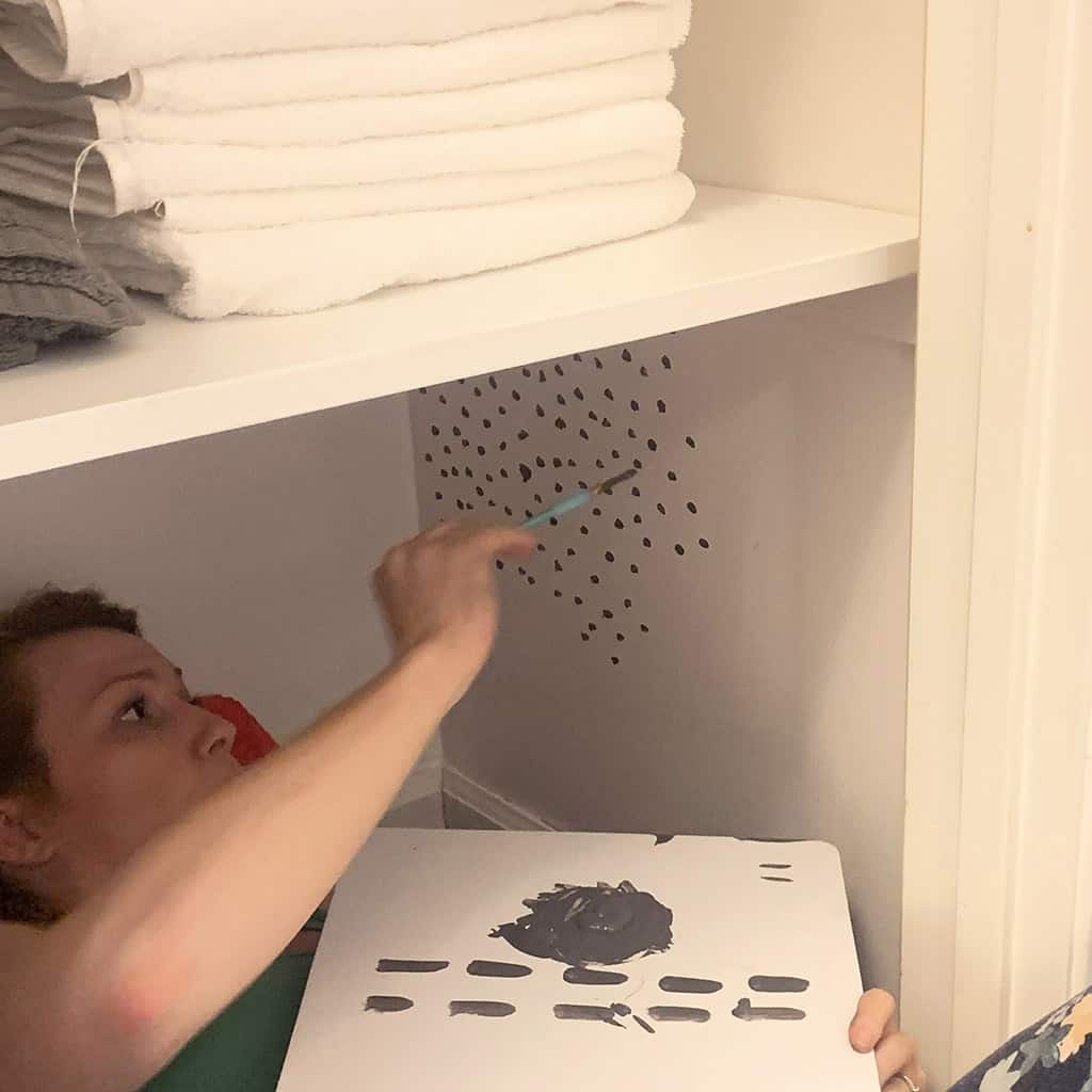 hand painted dot wallpaper in closet