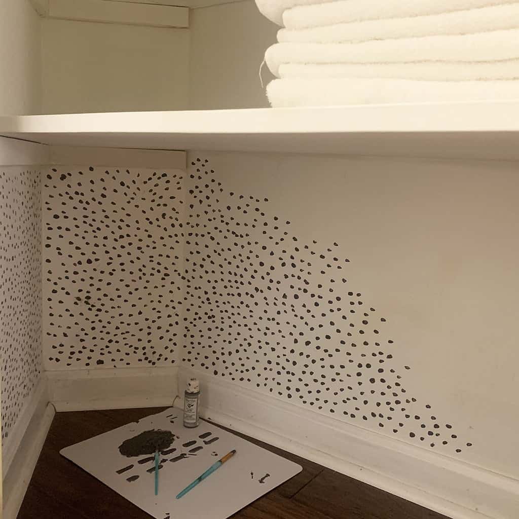 hand painted dot wallpaper in closet