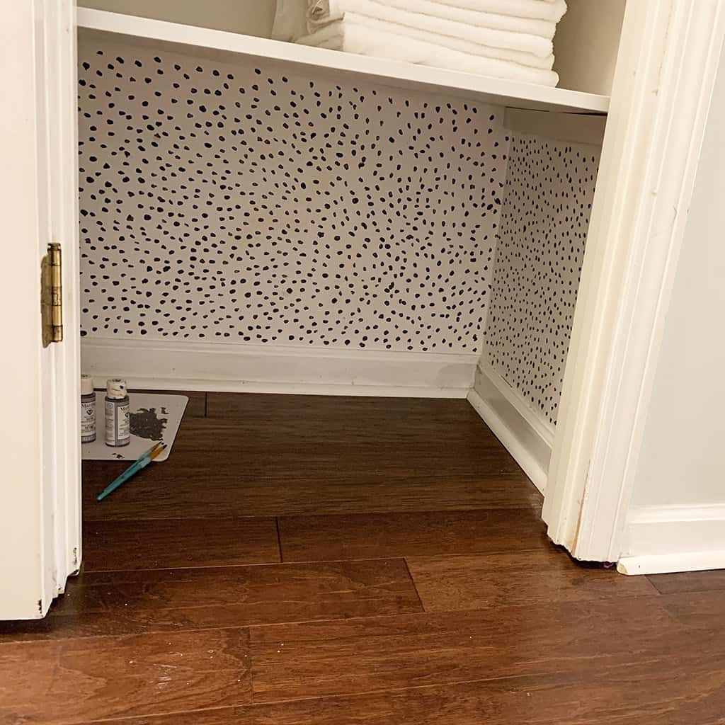 hand painted dot wallpaper in closet