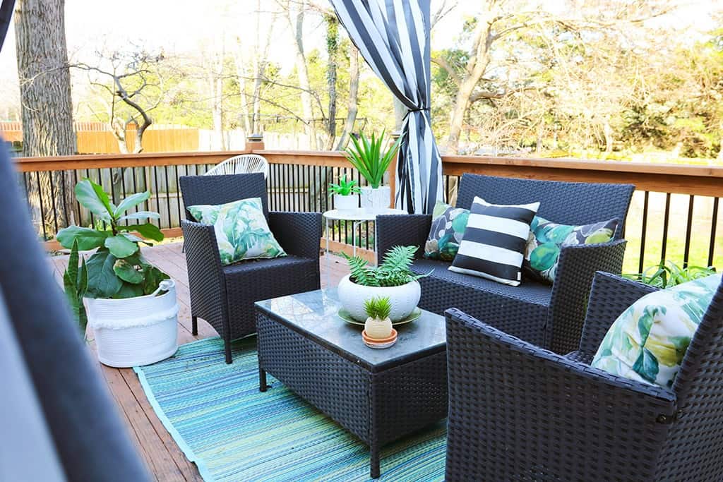 spring home tour deck pergola with palm and striped pillows