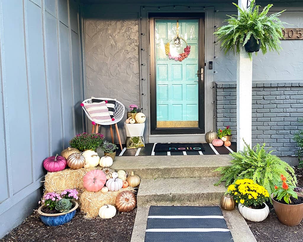 fall front porch with decor pumpkins and plants - outdoor fall decor