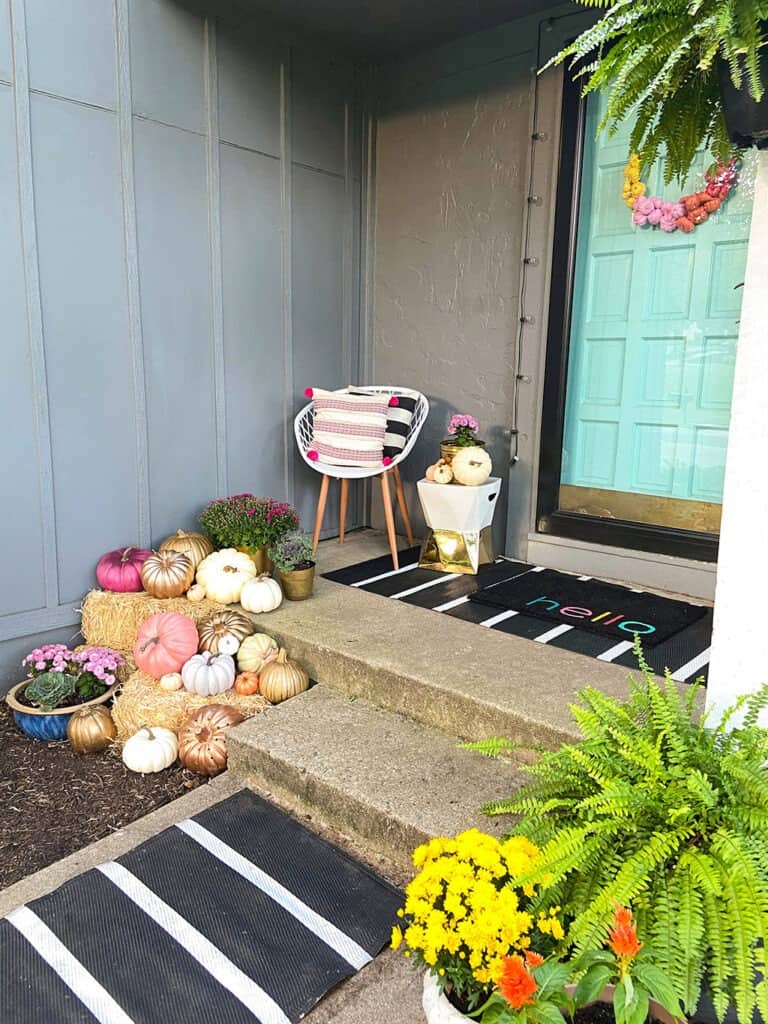 outdoor fall decor with plants and pumpkins