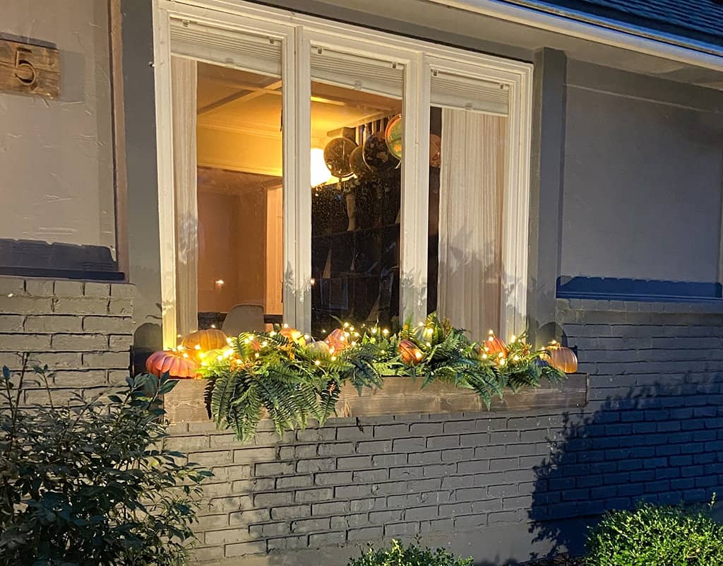 outdoor fall decor and window boxes with pumpkins and faux ferns