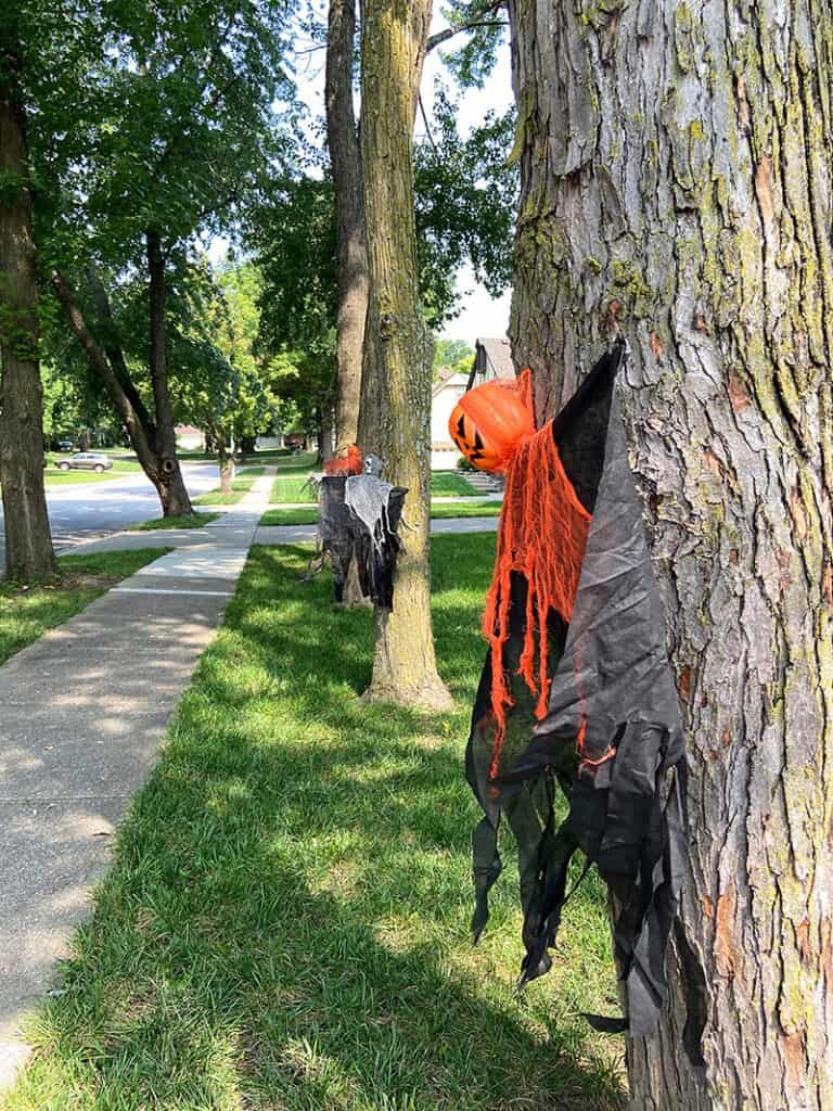 halloween ghouls in trees on sidewalk