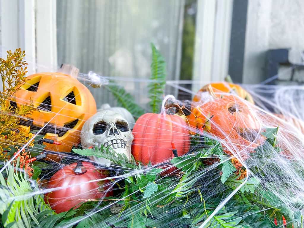 Faux pumpkins and spider webs! A fun & unique outdoor Halloween decor tour – at both day and nighttime! 
