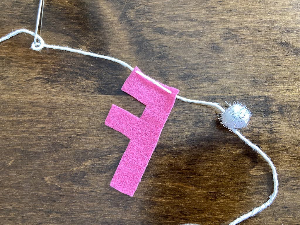 needle and yarn for stringing felt letters on a banner