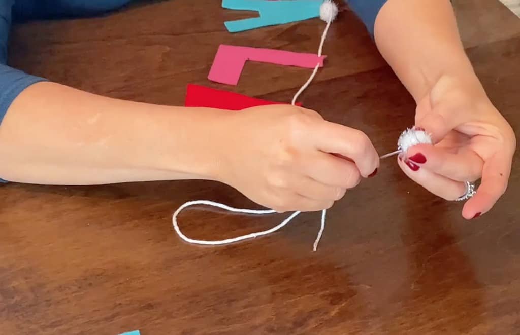 needle and yarn for stringing felt letters on a banner