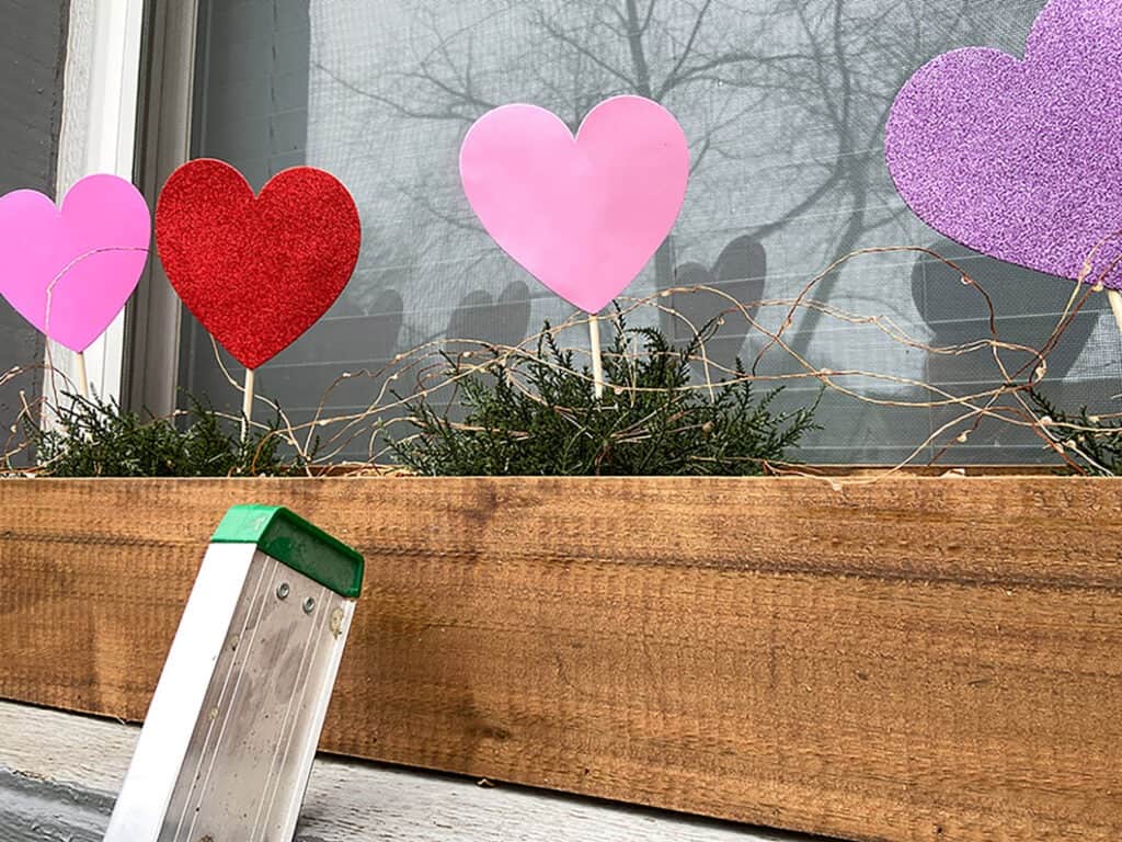 Foam heart picks in window box with fairy lights