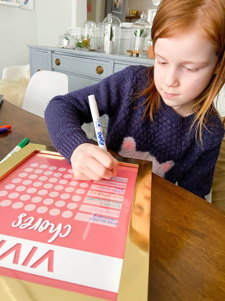 Adding chores to a kids DIY chore chart with dry erase markers 