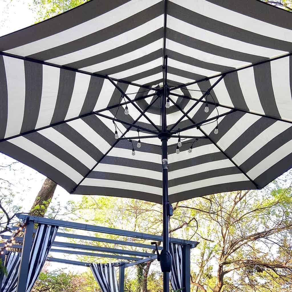 large wood deck with black and white strips and palm leaves