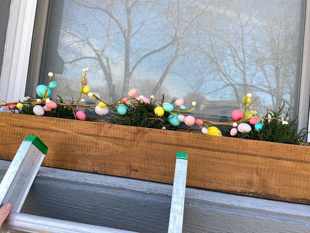 Easter decor ideas for your front porch and window boxes. Get the festive, cute, and colorful look quickly and affordably!