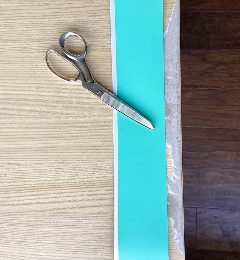 Cutting turquoise mint vinyl with scissors