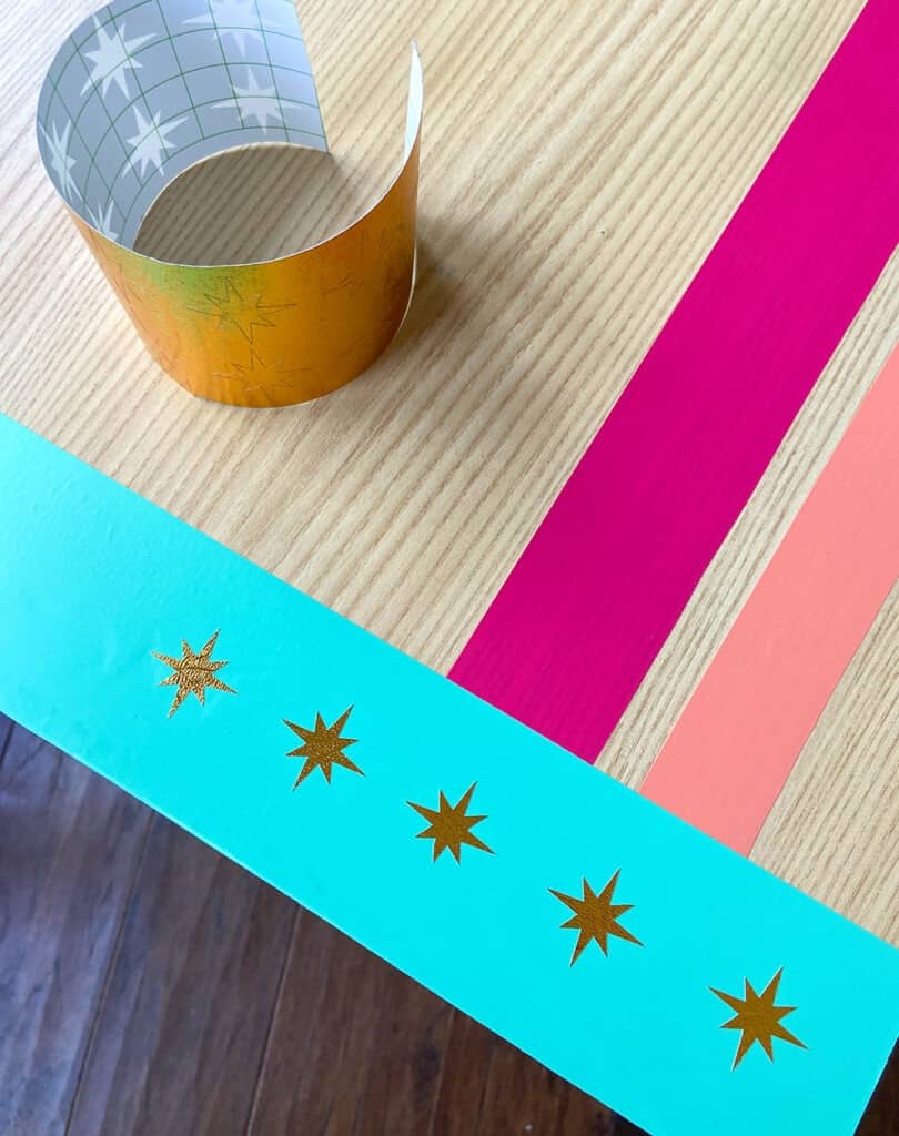 turquoise, hot pink, and coral vinyl design on a desk top with modern gold accents