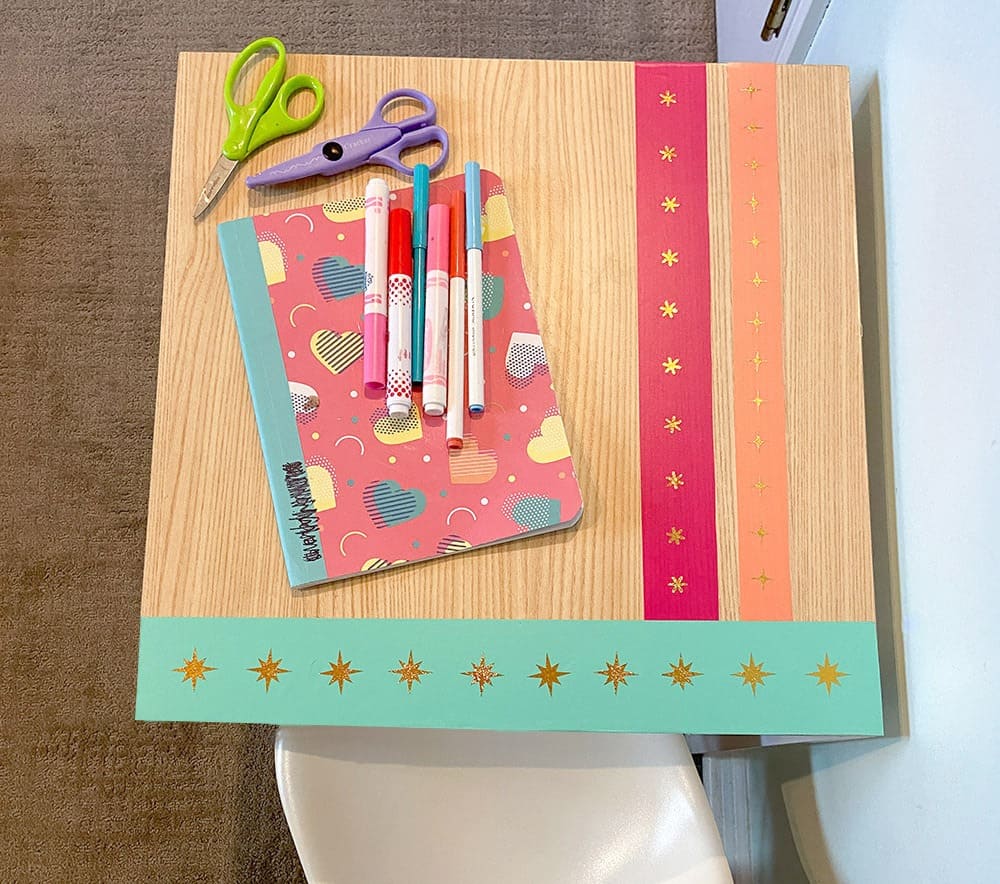 Using my Cricut Joy and some colorful vinyl, a fun and colorful table top design gave new life to our play room desk in just 10 minutes!