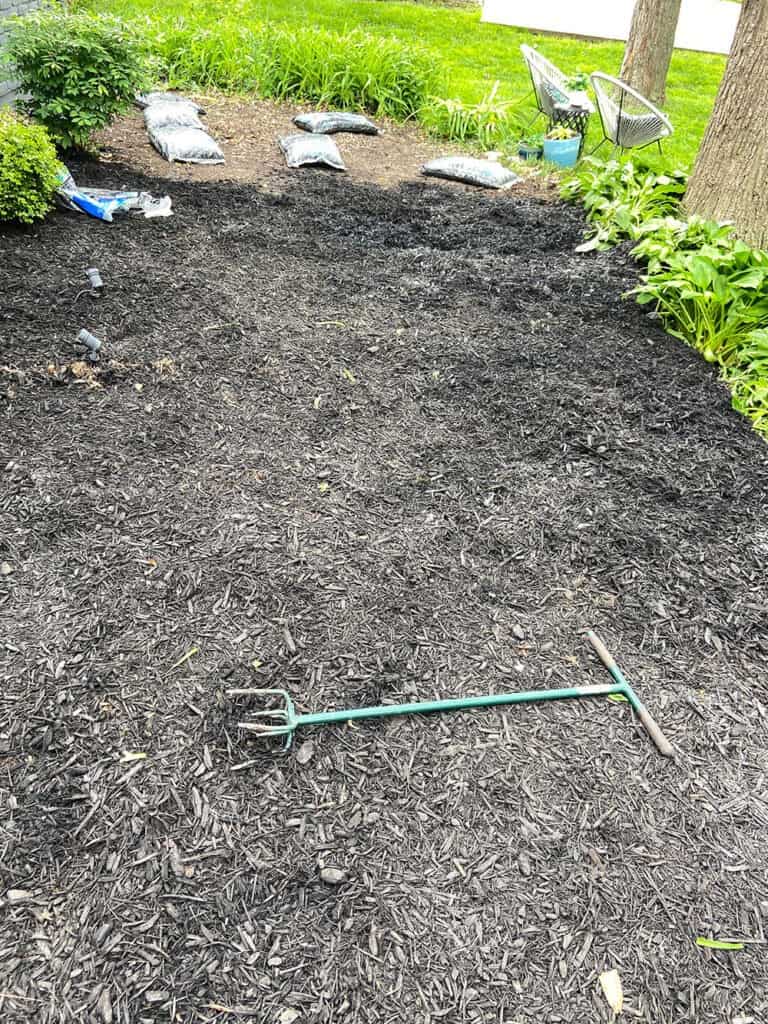 adding 45 bags of mulch to landscaping bed