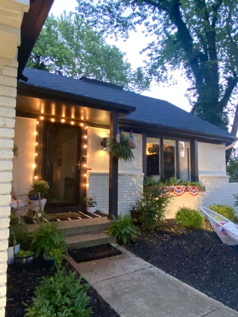 How a DIY wood cladding slat porch wall added some much needed warmth and curb appeal to our home! Get the full tutorial and product links. Exterior lights at night.