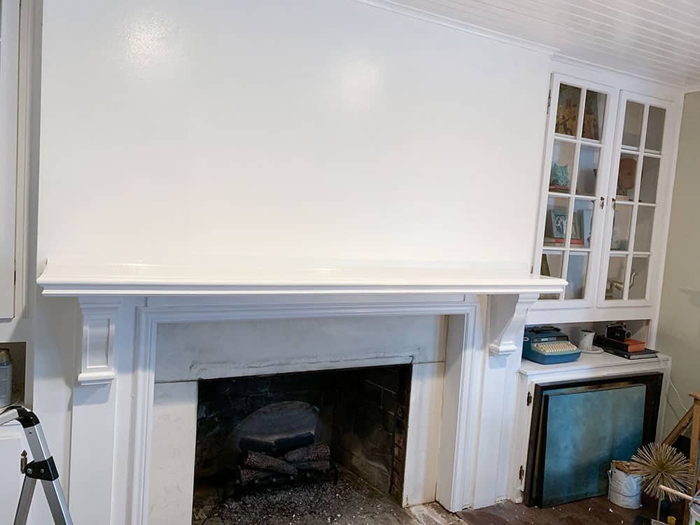 A step-by-step DIY fireplace makeover tutorial – See how it went from extra creepy to clean and classic on a very small budget! 