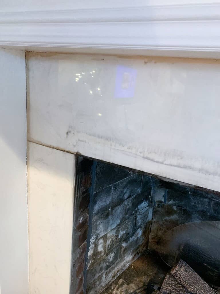 old fireplace tile - discovered brick behind it - fireplace makeover