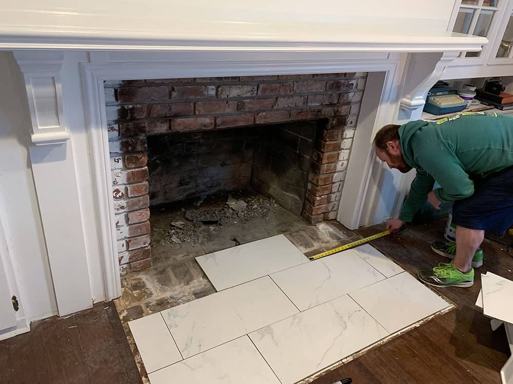 A step-by-step DIY fireplace makeover tutorial – See how it went from extra creepy to clean and classic on a very small budget! 