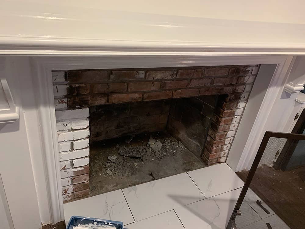 A step-by-step DIY fireplace makeover tutorial – See how it went from extra creepy to clean and classic on a very small budget! 