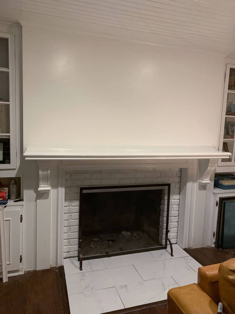 A step-by-step DIY fireplace makeover tutorial – See how it went from extra creepy to clean and classic on a very small budget! 