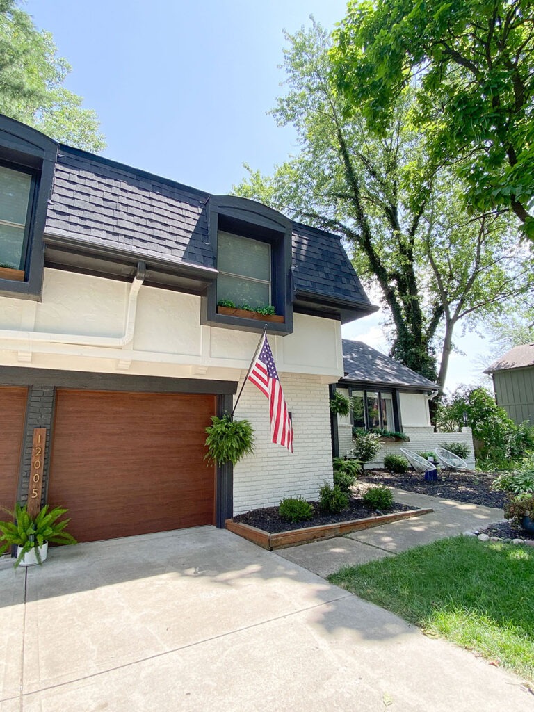 How a DIY wood cladding slat porch wall added some much needed warmth and curb appeal to our home! Get the full tutorial and product links. Sherwin-Williams Oyster white and Iron Ore trim.