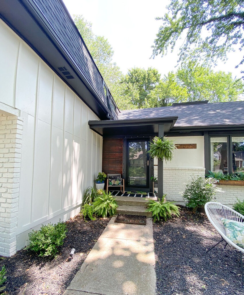 How a DIY wood cladding slat porch wall added some much needed warmth and curb appeal to our home! Get the full tutorial and product links. Sherwin-Williams Oyster white and Iron Ore trim.