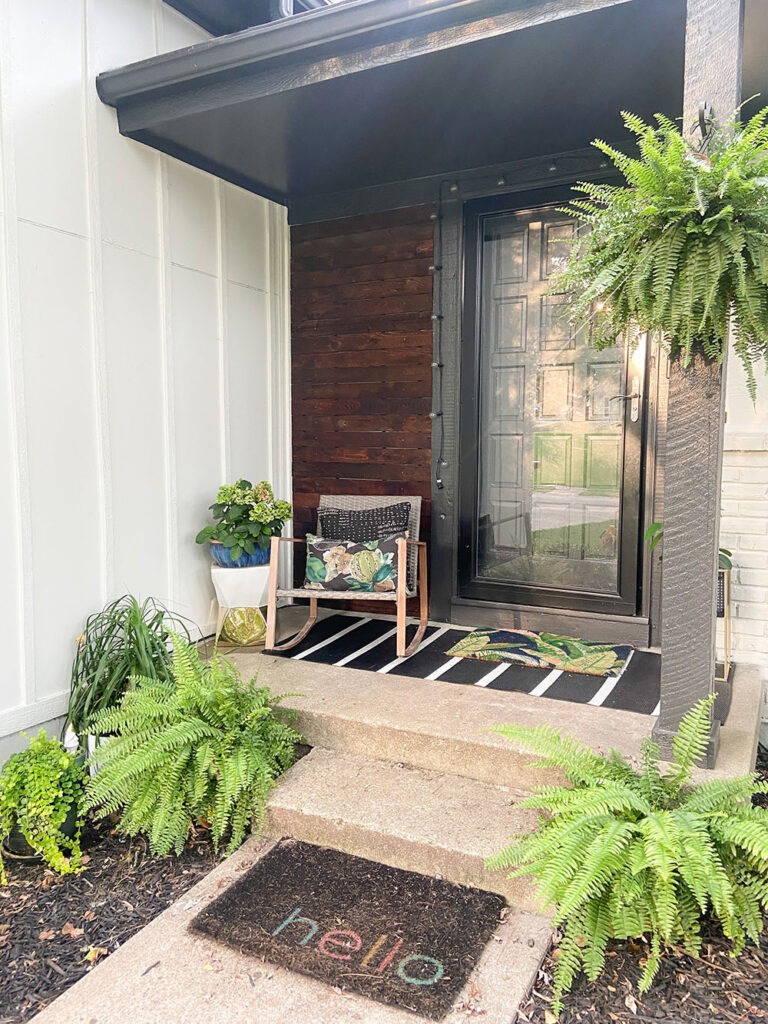 How a DIY wood cladding slat porch wall added some much needed warmth and curb appeal to our home! Get the full tutorial and product links.