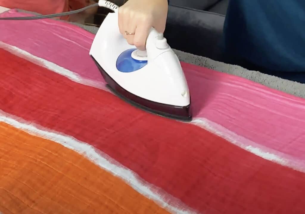 ironing the blanket to seal the dye