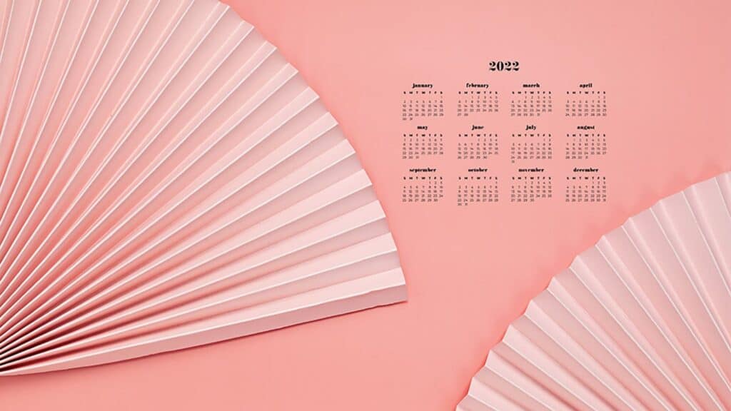 coral paper fans on coral background with 2022 full-year calendar for your desktop