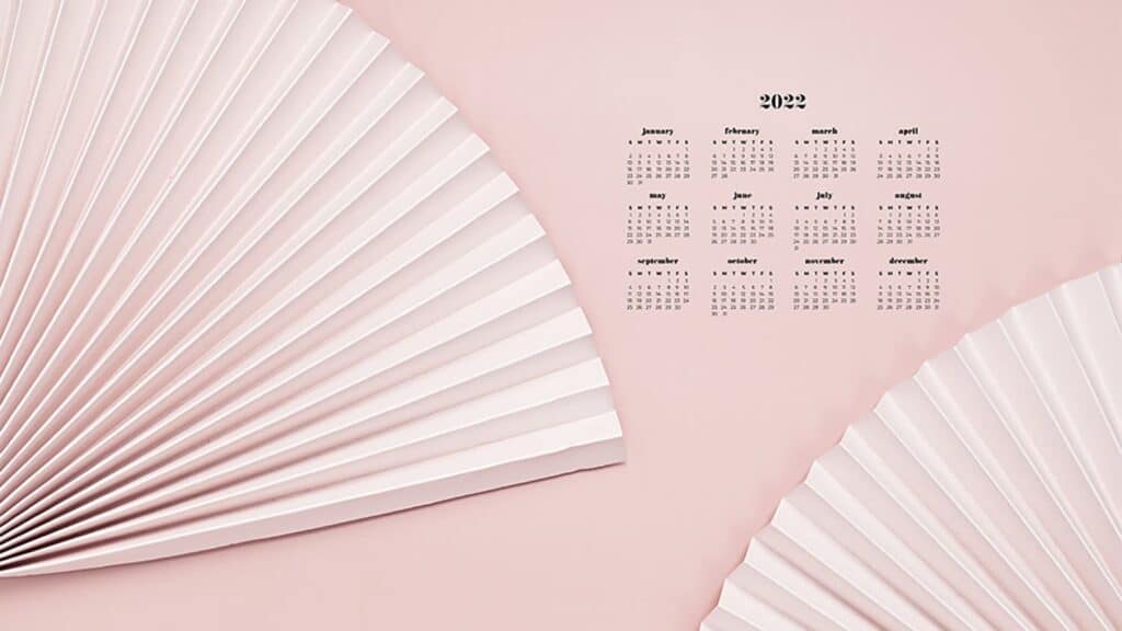 neutral blush paper fans on neutral blush background with 2022 full-year calendar for your desktop