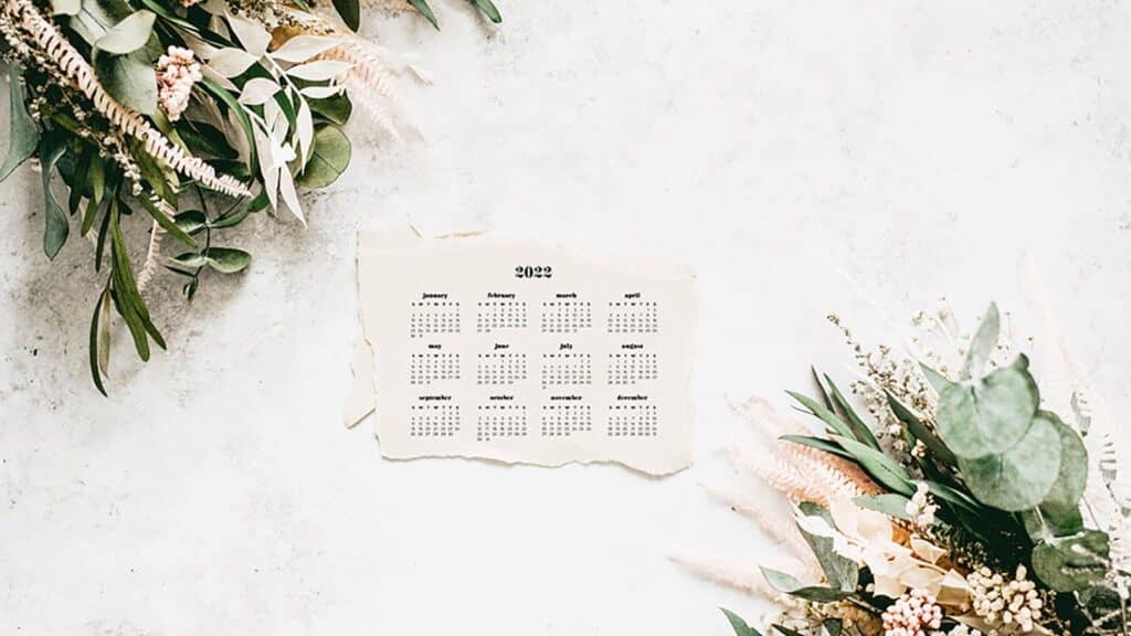 fresh flowers on stone background with free 2022 wallpapers full-year calendar for your desktop 