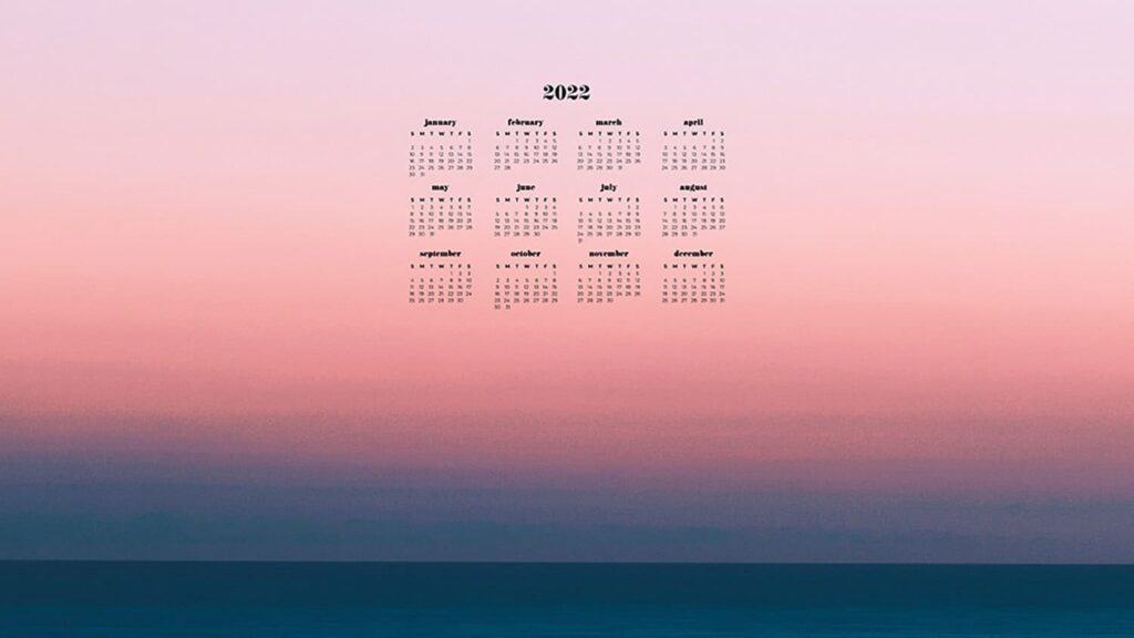 sunset on the ocean with 2022 full-year calendar