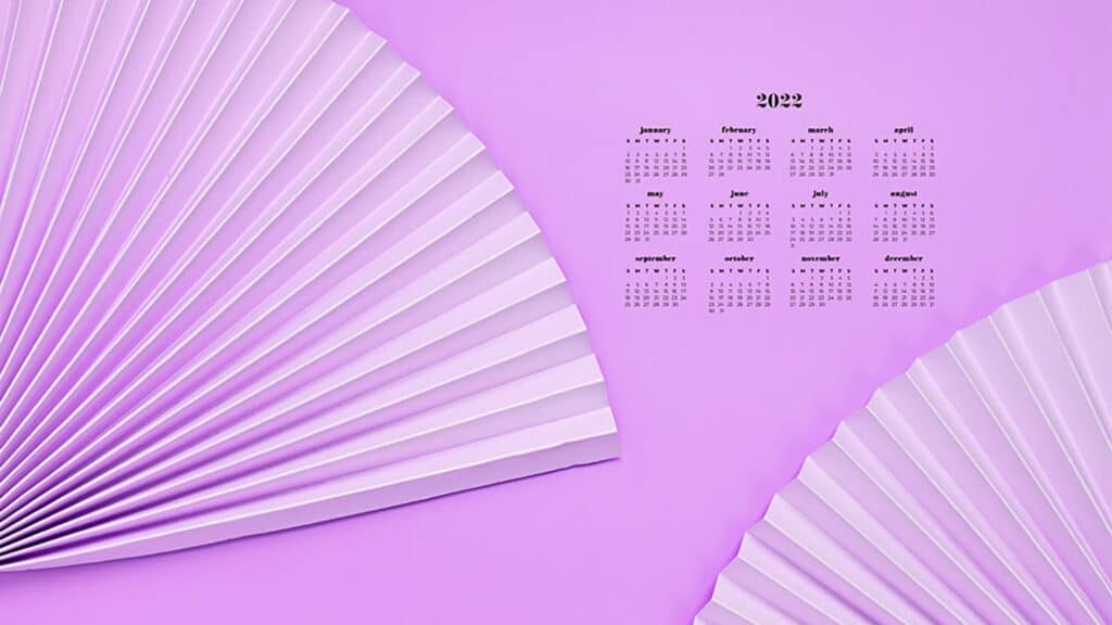 purple paper fans on purplebackground with 2022 full-year calendar for your desktop