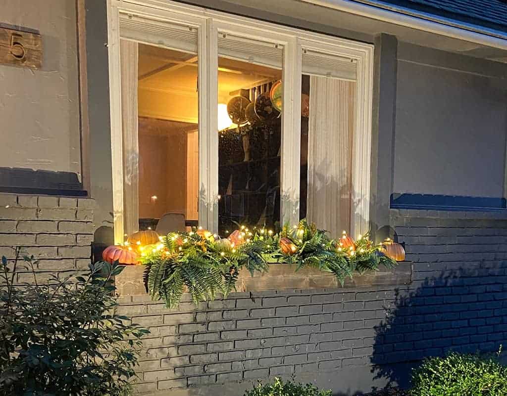 fall front porch and window boxes at night