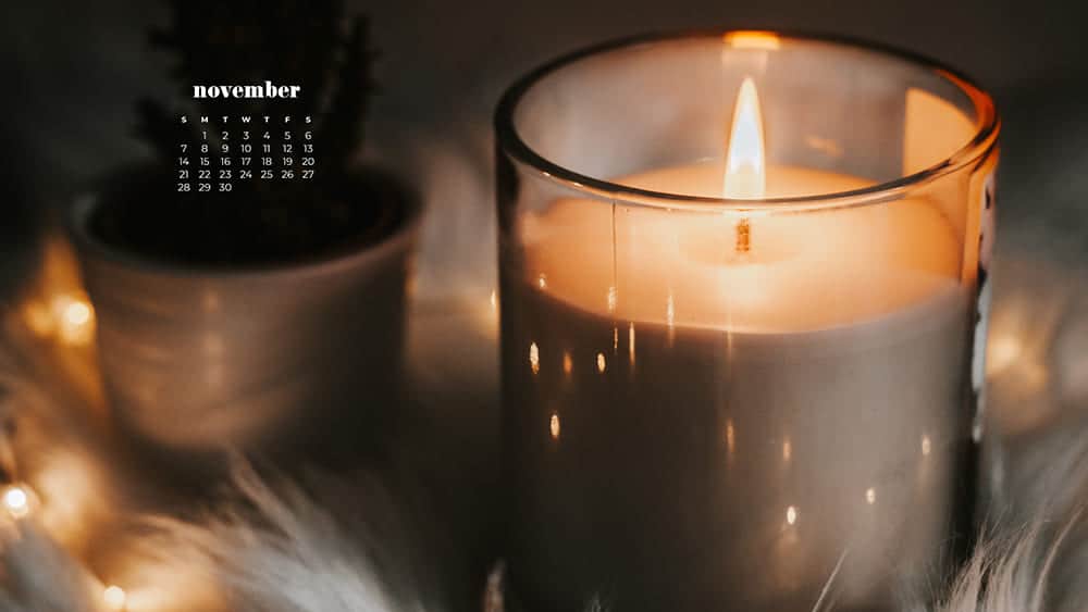 Cozy scene with a blanket, plant, and candle November - FREE wallpaper calendars in Sunday & Monday starts + no-calendar designs. 35 options for both desktop and smart phones!