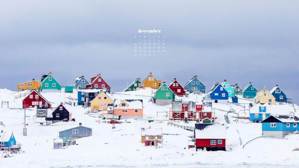 colorful cottages in snow on a hill - free december digital wallpapers