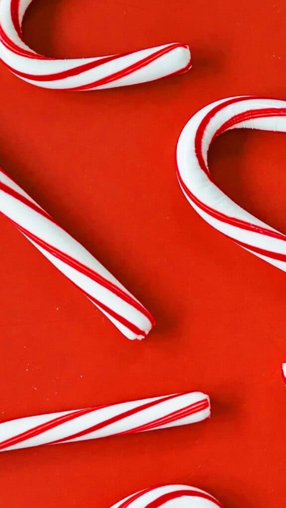 candy canes on red background - free december digital wallpapers