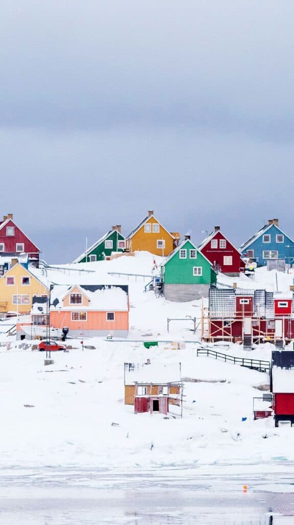 colorful cottages in snow on a hill - free december digital wallpapers