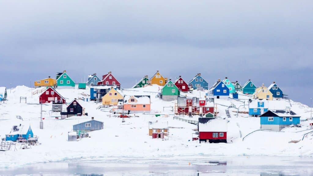 colorful cottages in snow on a hill - free december digital wallpapers