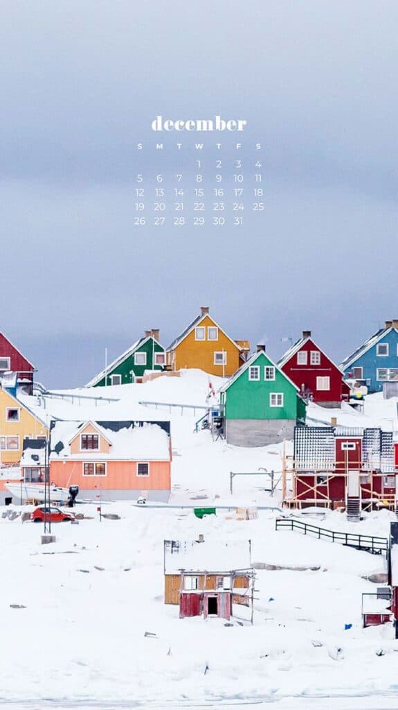 colorful cottages in snow on a hill - free december digital wallpapers