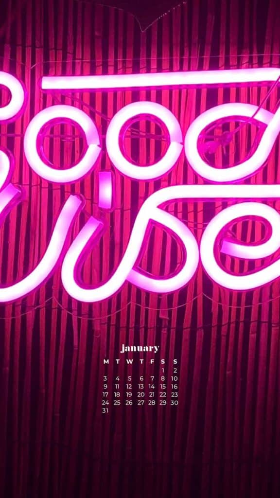 pink good vibes neon sign on bamboo background