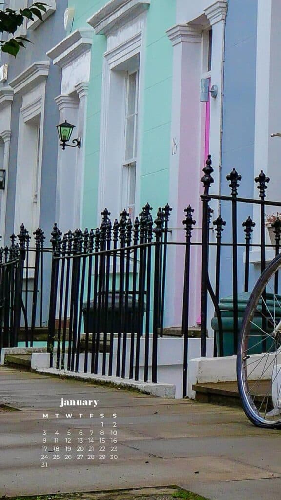 colorful homes in notting hill london with a bike leaning on gate