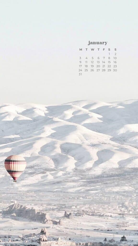 wintery snow covered mountains and hot air balloons