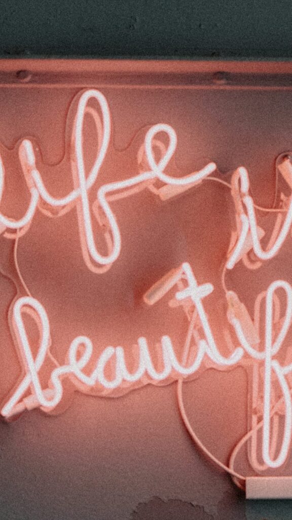 pink life is beautiful neon sign on white background