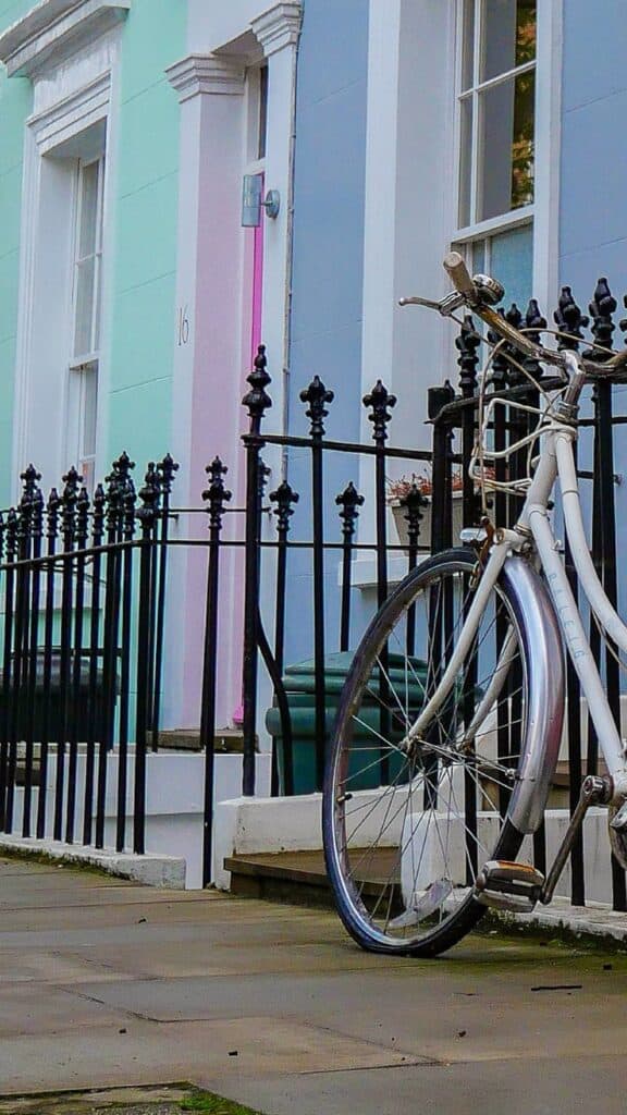 colorful homes in notting hill london with a bike leaning on gate