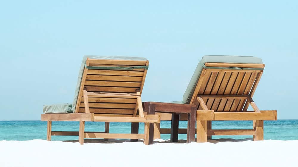 two beach chairs at the ocean